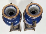 two vases that are sitting on a table