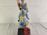 a figurine of a man riding a skateboard on top of a book
