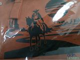 a picture of a man riding a horse on the beach