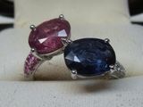 pair of blue and pink sapphire rings on display in a jewelry store