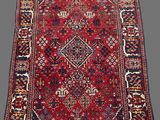 an antique persian rug with a red and blue design