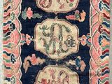a blue and pink rug with two lions on it