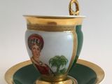 a cup and saucer with a picture of a woman on it