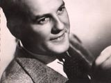 a black and white photo of a man in a suit and tie