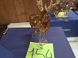 two glass deer figurines on a table with a price tag