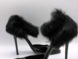 black high heeled shoes with fur on the toes on a white background