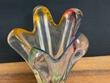a glass vase that is sitting on a wooden table