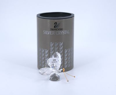 a close up of a tin of silver crystal next to a pin