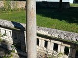 a stone column sitting in the middle of a park