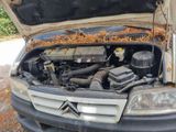 a car that has a bunch of junk in the hood