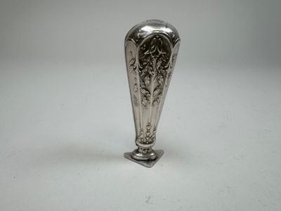 a silver vase that is sitting on a table