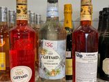 many bottles of alcohol lined up on a counter