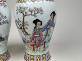 pair of chinese vases with a woman and a child on them