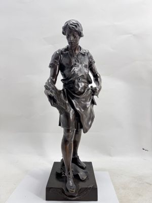 bronze statue of a boy holding a basket on a marble base