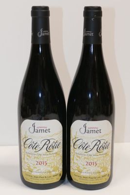 two bottles of wine sitting next to each other on a table