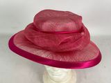 a close up of a pink hat on a mannequin head