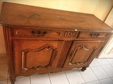 a large wooden cabinet with two drawers and a door