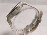a close up of a watch on a stand on a table