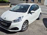 a white car parked in a parking lot next to a black car