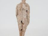 an image of a sculpture of a man standing on top of a wooden base