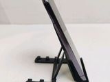 a cell phone sitting on a stand on a table