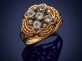 a gold ring with a cluster of diamonds set in the center