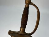 a close up of a sword on a white surface