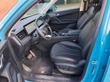 the interior of a blue car with the front seats folded down
