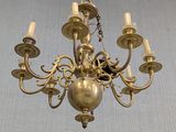 a gold chandelier hanging from the ceiling in a room