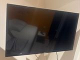 a flat screen tv hanging on a wall in a room