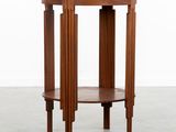 a round wooden table with three legs and a wooden top