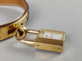a gold bracelet with a padlock attached to it