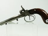 an old gun with a wooden handle on display in a glass case