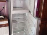 a white refrigerator with its door open in a kitchen