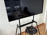 a flat screen tv sitting on a stand in the corner of a room