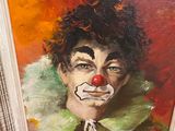 painting of a clown with a red nose and a green jacket