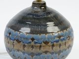 a blue and brown vase with a light on it