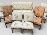 six chairs with floral upholstered cushions and wooden legs