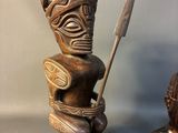 pair of african carved wood statues of a warrior and a woman