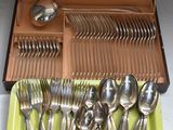 a tray with silverware in it on a table
