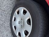 a red car that has a flat tire on it