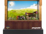 un présentoir de jouets comprenant un tracteur et un décor de ferme