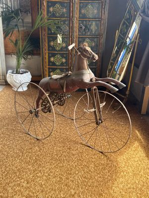 a toy horse on a bicycle in a living room