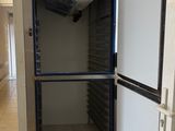 an image of a refrigerator in a building with the door open