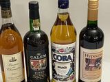 several bottles of wine are lined up on a white surface