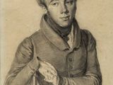 portrait of a man with curly hair sitting in a chair