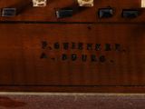 a wooden box with four knobs on top of it