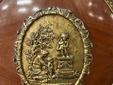 a gold plate with a picture of a man and a woman on it