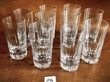 six shot glasses sitting on top of a brown table next to each other