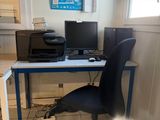 a desk with a computer and a printer on it